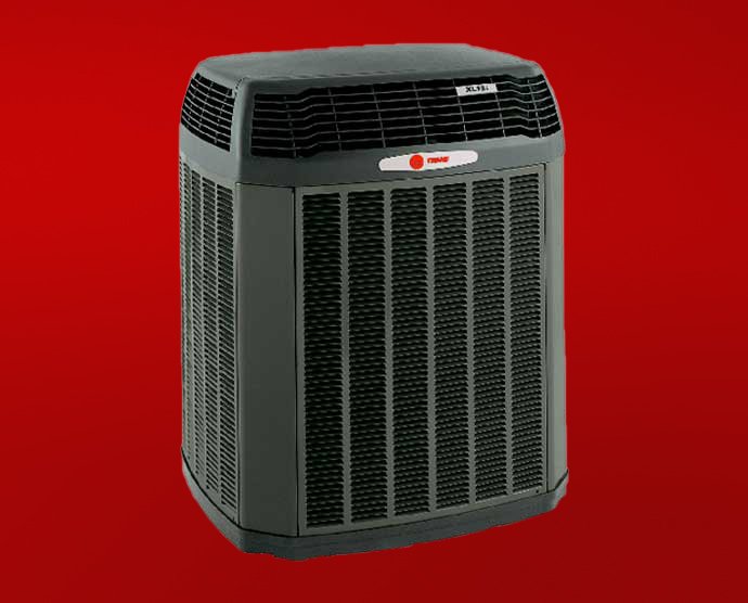 A black Trane outdoor HVAC unit is shown against a solid red background, highlighting the importance of regular air conditioner maintenance to help prevent AC overheating.